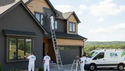 Professional house painters in Harrisburg PA applying fresh exterior paint to a residential home